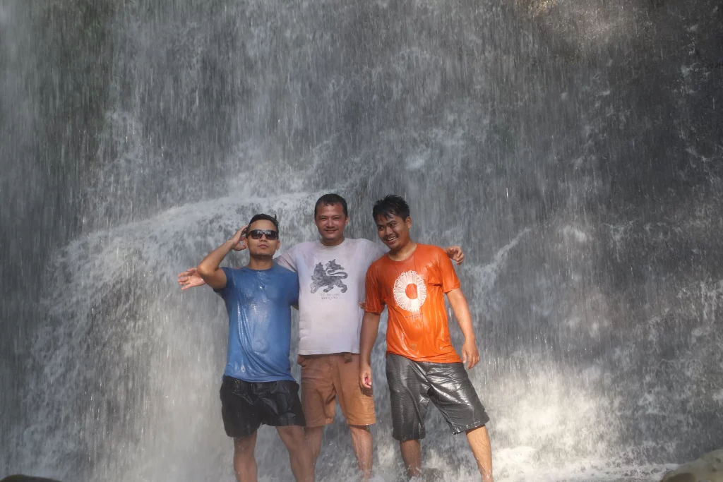 At a waterfall with group of friends while camping